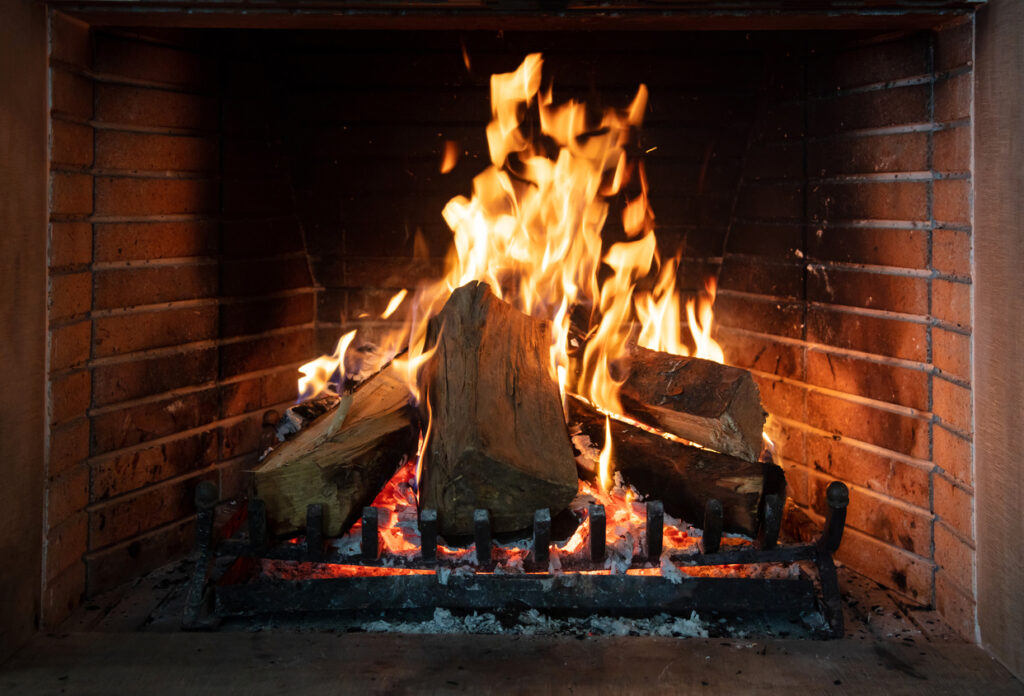 Burning fireplace, real wood logs, cozy warm home at xmas time